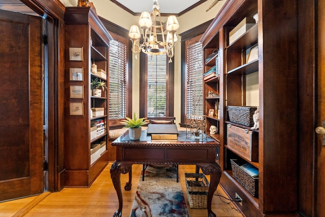 office with ornamental molding, an inviting chandelier, and wood finished floors