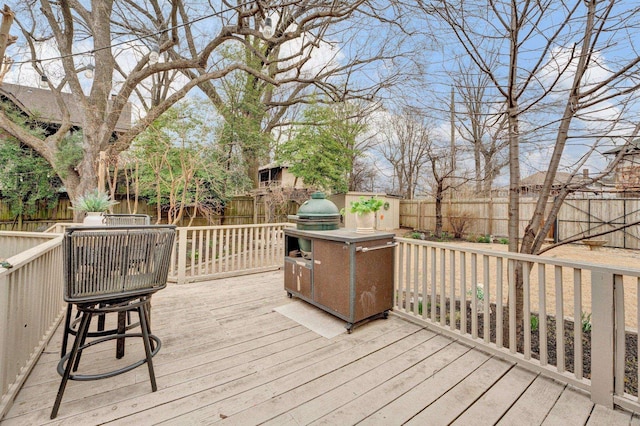 wooden terrace with a fenced backyard