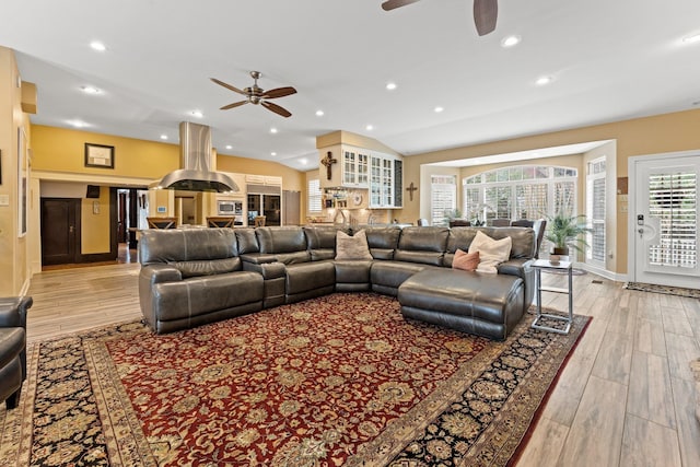 living area featuring recessed lighting, light wood-type flooring, lofted ceiling, and ceiling fan