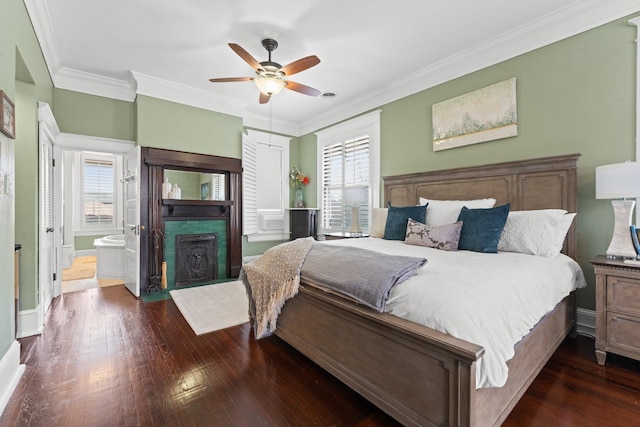 bedroom featuring a fireplace with flush hearth, multiple windows, ornamental molding, and hardwood / wood-style floors