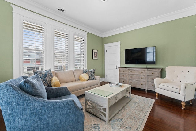 living room featuring visible vents, crown molding, and wood finished floors