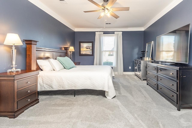 carpeted bedroom with baseboards, crown molding, and a ceiling fan