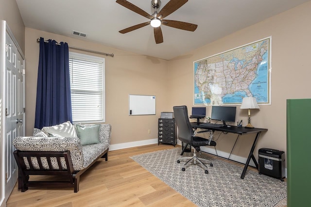 office space featuring visible vents, baseboards, wood finished floors, and a ceiling fan