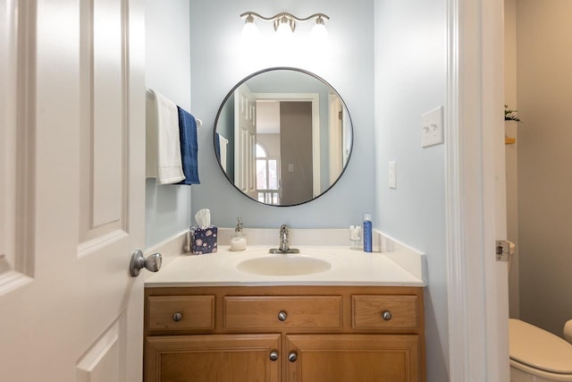 bathroom featuring toilet and vanity