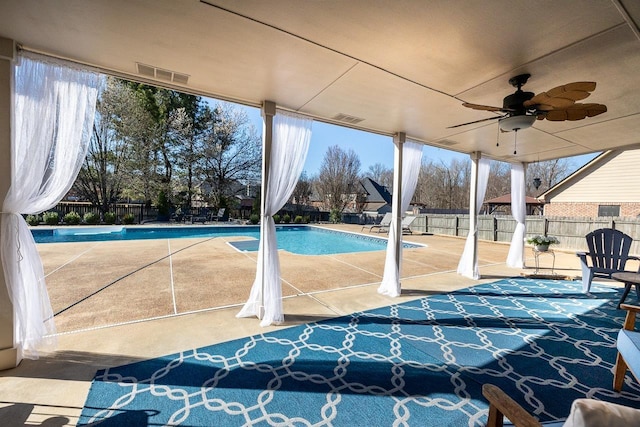 view of pool with a fenced in pool, a patio, a fenced backyard, and a ceiling fan