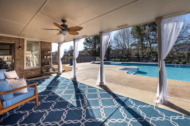 view of pool featuring a fenced backyard, a fenced in pool, a patio, and ceiling fan