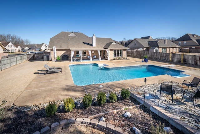 view of swimming pool featuring a residential view, a patio area, a fenced in pool, and a fenced backyard