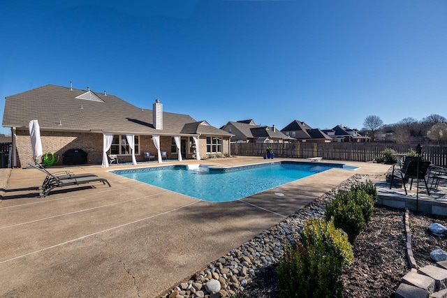 view of pool with a patio area, a fenced in pool, and a fenced backyard