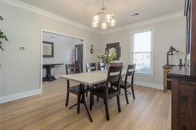 dining space with visible vents, light wood-style floors, crown molding, baseboards, and a chandelier