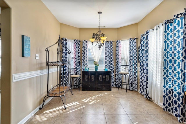 entrance foyer with tile patterned floors, a notable chandelier, baseboards, and visible vents