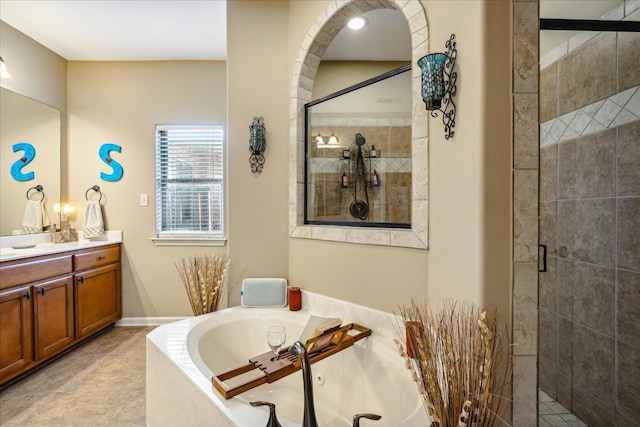 full bath featuring vanity, a shower stall, a bath, and tile patterned floors