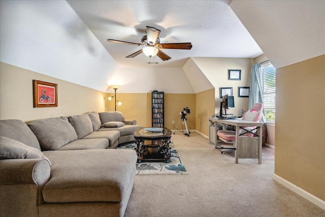 living room with light carpet, a ceiling fan, a textured ceiling, baseboards, and vaulted ceiling