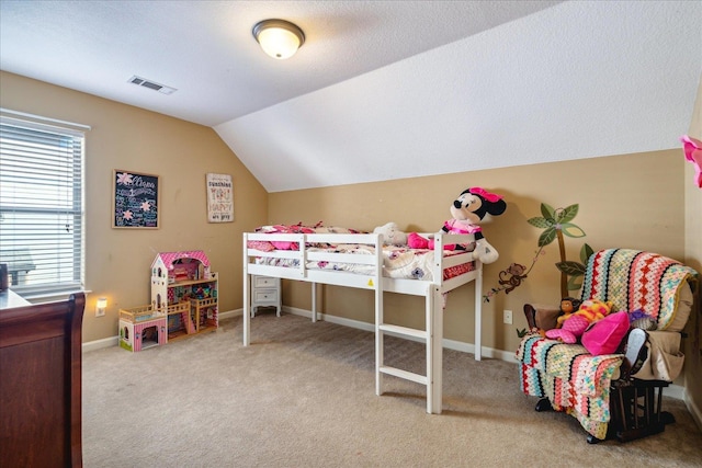 carpeted bedroom with lofted ceiling, baseboards, visible vents, and a textured ceiling