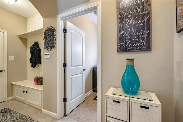 mudroom with baseboards and arched walkways