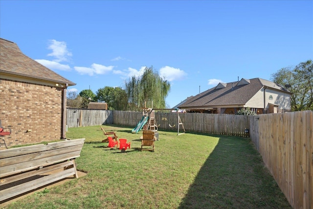 view of yard with a fenced backyard and a playground