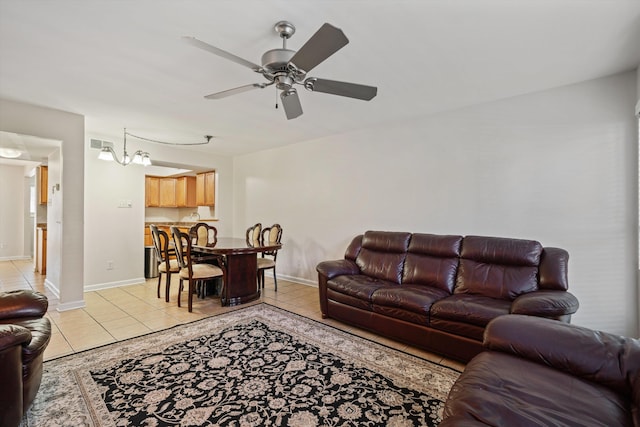 living area with light tile patterned floors, visible vents, baseboards, and ceiling fan