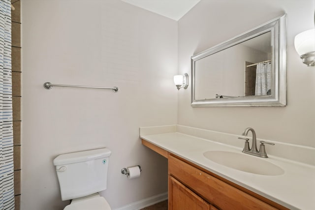 bathroom featuring curtained shower, toilet, and vanity