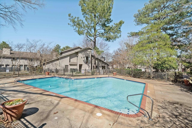 community pool featuring a patio and fence