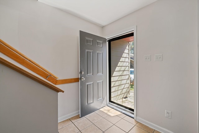 entryway featuring light tile patterned floors and baseboards