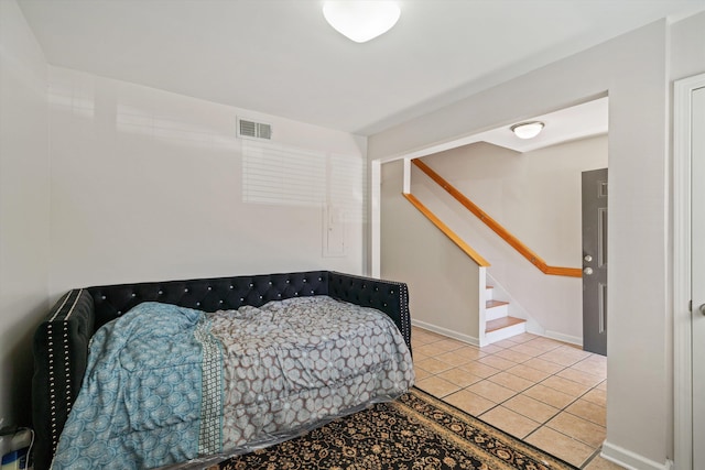 bedroom with visible vents, baseboards, and light tile patterned flooring