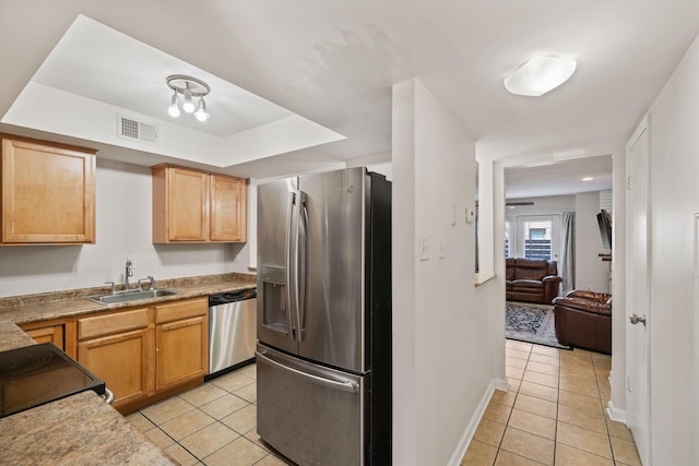 kitchen featuring a sink, light tile patterned floors, visible vents, and stainless steel appliances