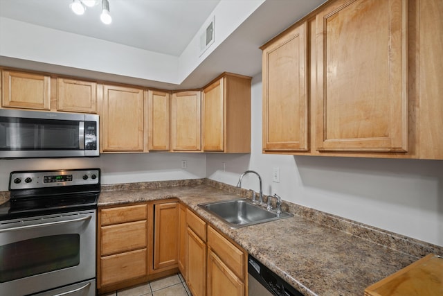 kitchen with visible vents, light tile patterned flooring, light brown cabinetry, a sink, and appliances with stainless steel finishes