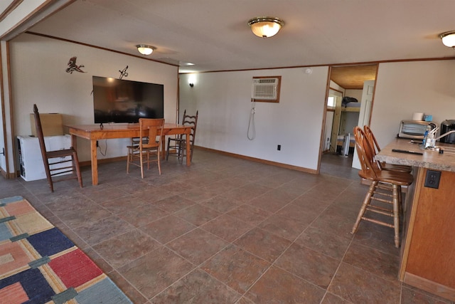 dining space featuring crown molding, an AC wall unit, and baseboards