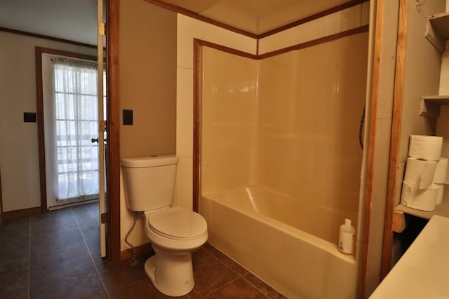 bathroom featuring tile patterned floors, baseboards, toilet, and shower / tub combination