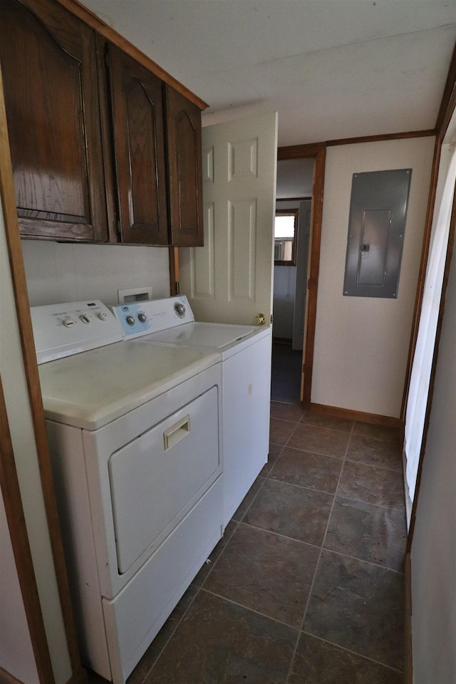 clothes washing area with electric panel, cabinet space, baseboards, and washing machine and clothes dryer