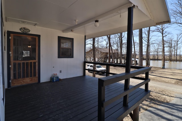 wooden terrace featuring a water view