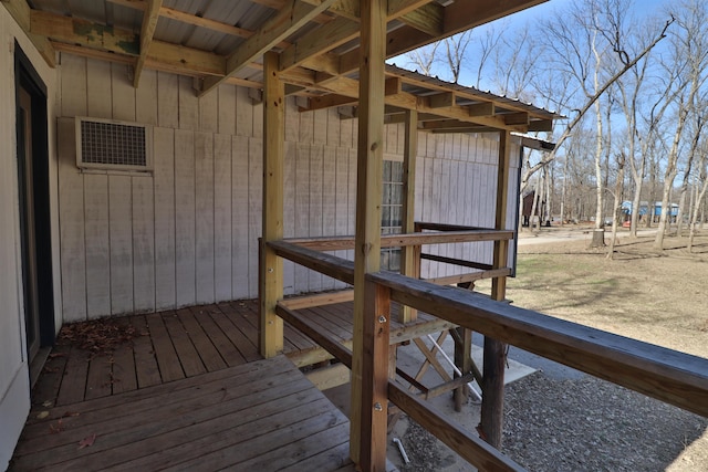 wooden deck featuring visible vents and an outdoor structure