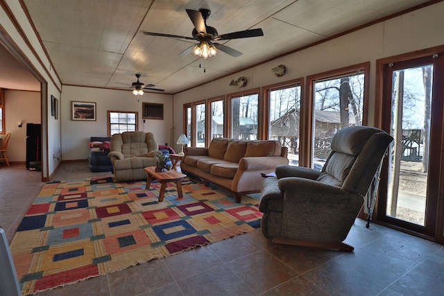 living area with a healthy amount of sunlight, wood ceiling, and a ceiling fan