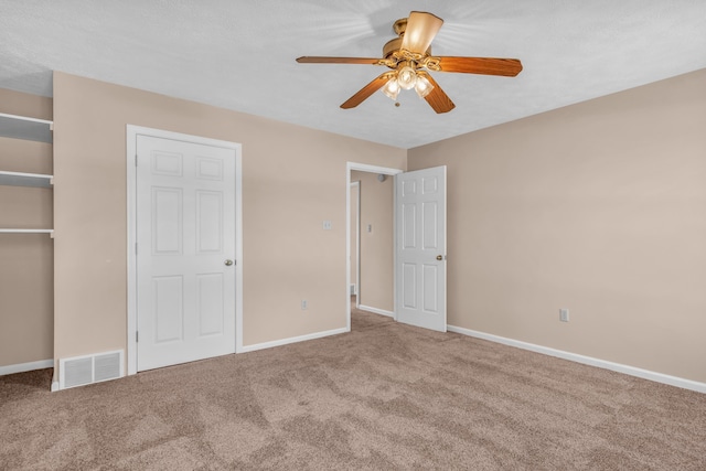 unfurnished bedroom with visible vents, baseboards, ceiling fan, carpet flooring, and a textured ceiling