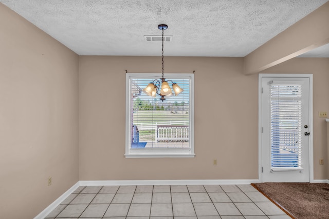 interior space featuring an inviting chandelier, light tile patterned floors, baseboards, and visible vents