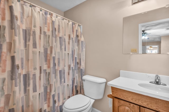 full bathroom with a shower with shower curtain, toilet, vanity, and a ceiling fan