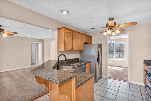 kitchen featuring a kitchen bar, light carpet, black appliances, a sink, and a peninsula