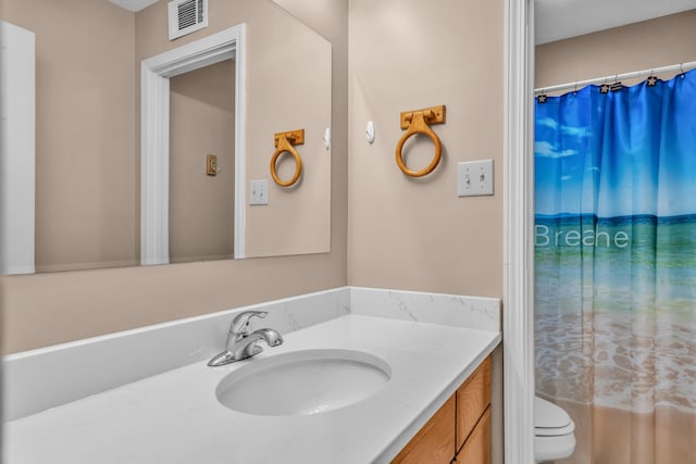 bathroom with visible vents, toilet, vanity, and a shower with curtain