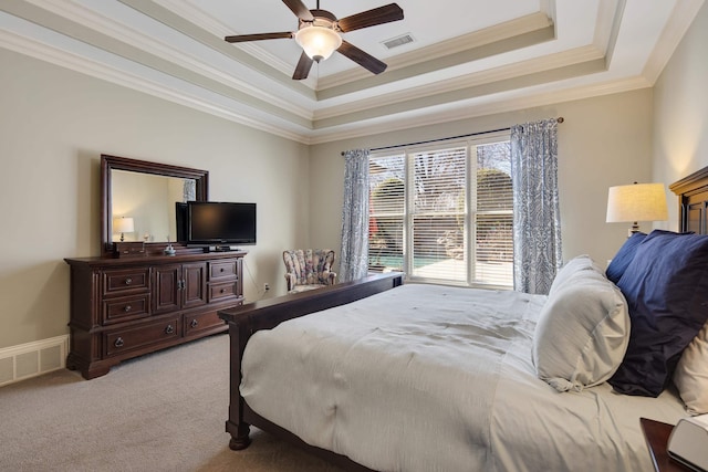 bedroom with visible vents, a raised ceiling, light carpet, and ornamental molding