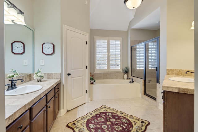 full bathroom featuring tile patterned flooring, a shower stall, a garden tub, and vanity