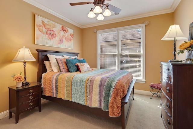 bedroom featuring baseboards, light carpet, a ceiling fan, and crown molding