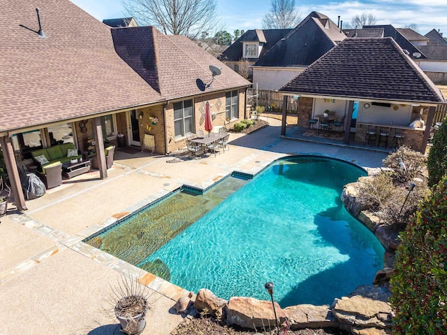 view of swimming pool featuring a fenced in pool, a patio, and fence