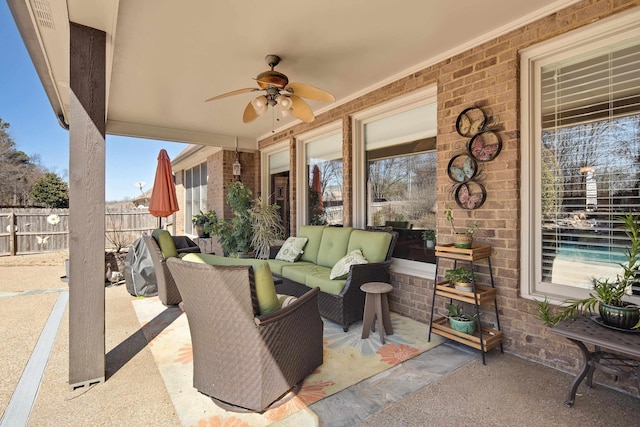 view of patio / terrace with an outdoor living space, a ceiling fan, and fence