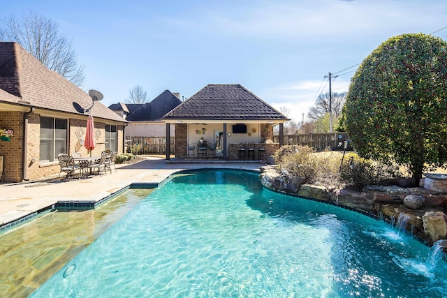 view of pool featuring a fenced in pool, fence, outdoor dry bar, and a patio area