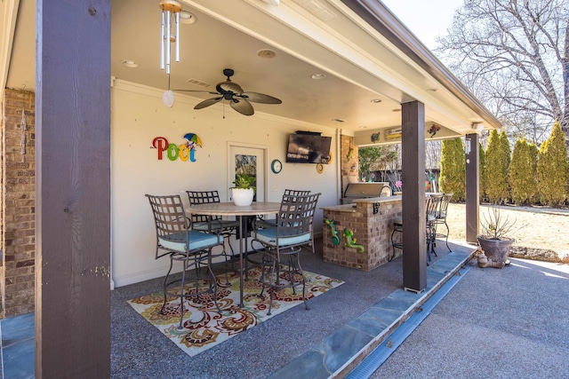 view of patio / terrace featuring visible vents, an outdoor kitchen, outdoor wet bar, outdoor dining area, and ceiling fan