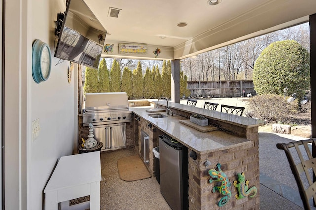 view of patio / terrace with visible vents, fence, outdoor wet bar, a grill, and a sink