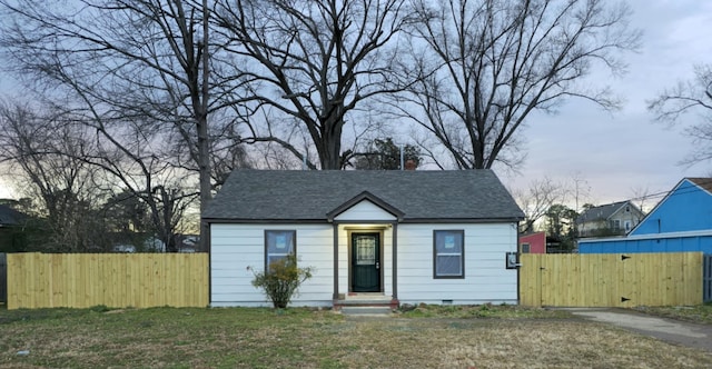 view of front of home with a gate, fence, a shingled roof, a front lawn, and crawl space