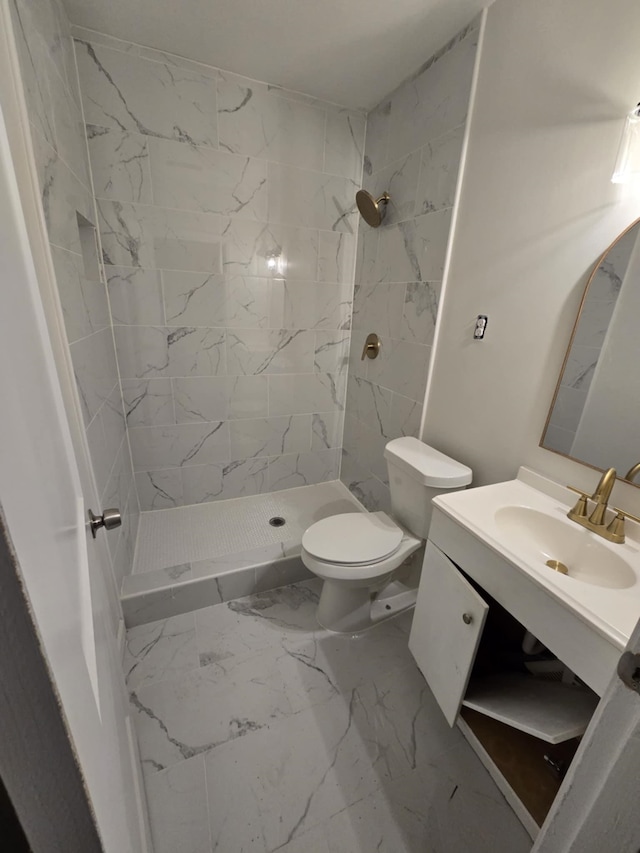 bathroom with vanity, a shower stall, toilet, and marble finish floor