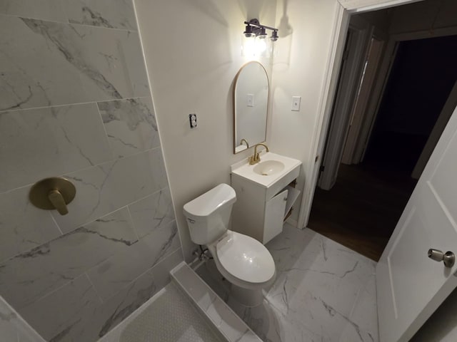 bathroom featuring vanity, toilet, and marble finish floor