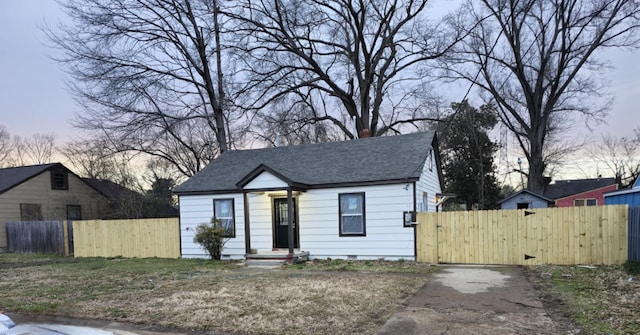 bungalow featuring crawl space, a gate, fence, and a shingled roof