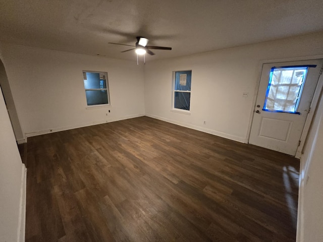 foyer featuring a ceiling fan, dark wood-style floors, and baseboards